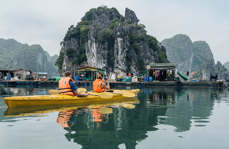 A fisherman paddling in Halong Bay