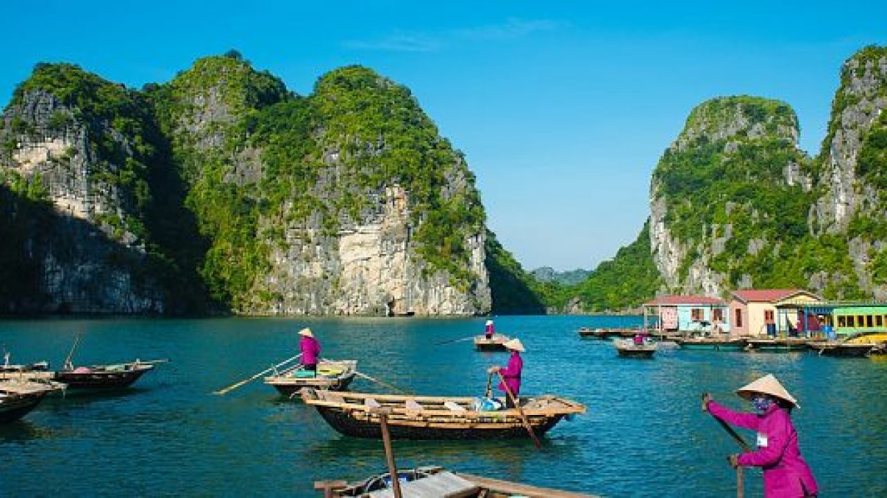 Kayaking through a floating village in Halong Bay